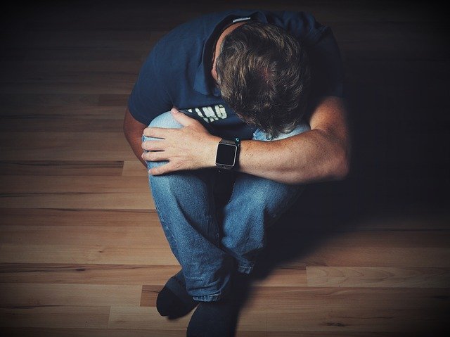 man crouched on legs